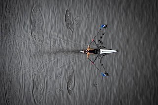 Image of a solo rower on a river